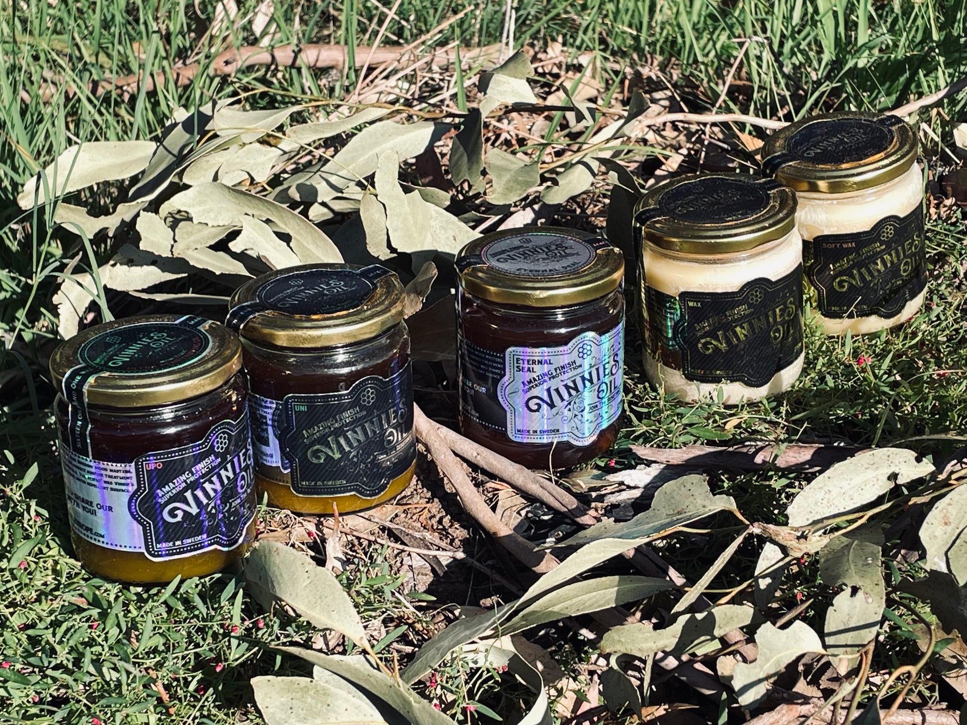 Jars of Vinnies Oil with visible branding on a natural background grass and bushland setting