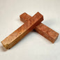 Two Red Mallee Burl Pen Blanks, crossed at the centre, displayed on a light grey textured background.