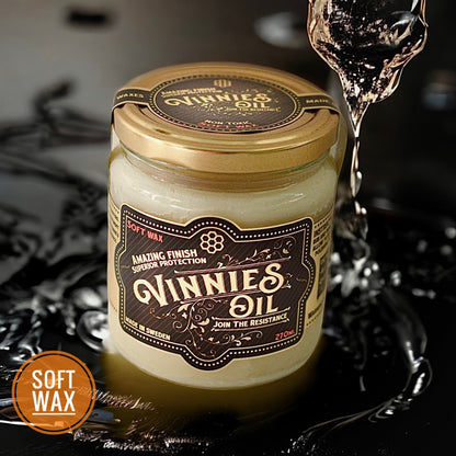 Jar of Vinnie's Oil with a decorative label on a dark background